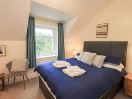 A bedroom with a bed and window at Hazelmere in Keswick