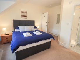 A bedroom with a bed and en-suite shower at Hazelmere in Keswick