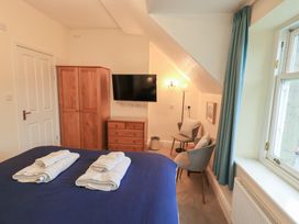 A bedroom with a bed and wardrobe at Hazelmere in Keswick