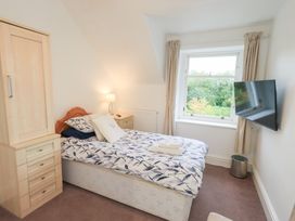 A bedroom with a bed and wardrobe at Hazelmere in Keswick