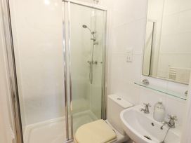 A bathroom with a shower, toilet, and sink at Hazelmere in Keswick