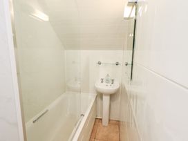 A bathroom with a bathtub, sink, and shower at Hazelmere in Keswick