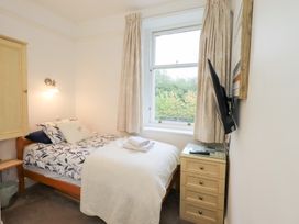 A bedroom with a bed and nightstand at Hazelmere in Keswick