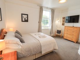 A bedroom with a bed and dresser at Hazelmere in Keswick
