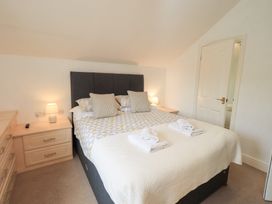 A bedroom with a bed and nightstand at Hazelmere in Keswick