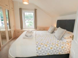 A bedroom with a bed and wardrobe at Hazelmere in Keswick