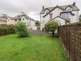 A garden area with a house and fence at Hazelmere in Keswick