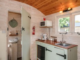 A kitchen area with a sink and cabinet at Aston - Shepherd Hut Aston On Clun