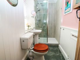 A bathroom with a shower, toilet, and sink at Maenllwyd in Borth-Y-Gest near Porthmadog