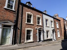 A row of brick houses on a street at Charlotte House in Whitby