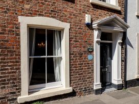 An exterior view of Charlotte House featuring a window and door in Whitby