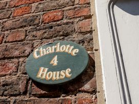 House sign on a brick wall at Charlotte House in Whitby