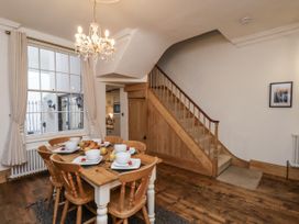A dining room with a table and chairs at Charlotte House in Whitby