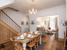 A dining room with a table set for breakfast at Charlotte House in Whitby