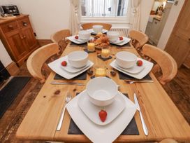 A dining table with bowls and strawberries at Charlotte House in Whitby