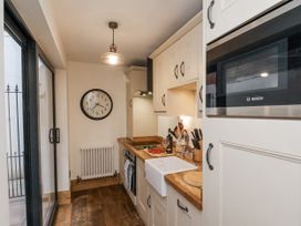A kitchen with a sink and cabinets at Charlotte House in Whitby