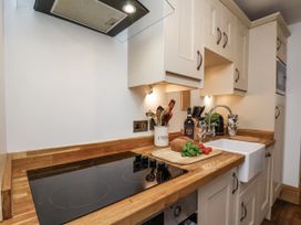 A kitchen with a cooking stove and sink at Charlotte House in Whitby