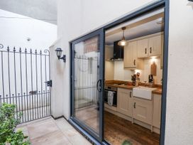 A kitchen with a view of a gated area at Charlotte House in Whitby