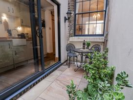 A small patio area with a table and chairs at Charlotte House Whitby