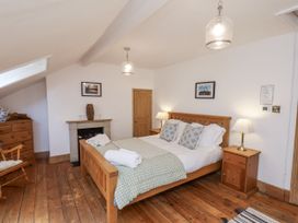 A bedroom with a bed and furniture at Charlotte House in Whitby