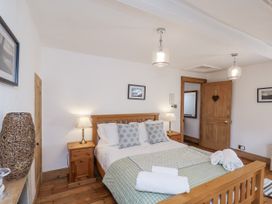 A bedroom with a bed and nightstand at Charlotte House in Whitby
