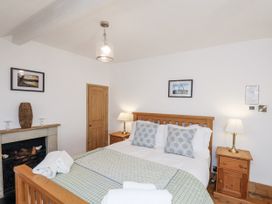 A bedroom with a bed and nightstands at Charlotte House in Whitby