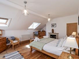 A bedroom with a bed and light fixtures at Charlotte House in Whitby
