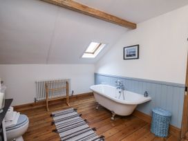 A bathroom with a bathtub and toilet at Charlotte House in Whitby