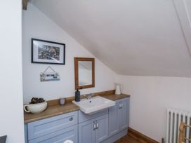 A bathroom with sink and mirror at Charlotte House in Whitby