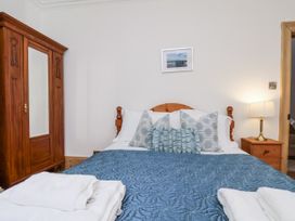 A bedroom with a bed and wardrobe at Charlotte House in Whitby