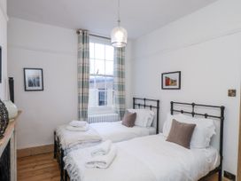 A bedroom with two beds and a window at Charlotte House in Whitby