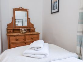 A bedroom with a mirror and dresser at Charlotte House in Whitby