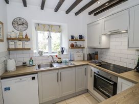 A kitchen with sink and oven at Dairy Cottage in Witney