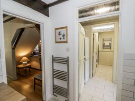 A hallway with a lamp and furniture at Dairy Cottage in Witney