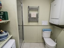 A bathroom with a toilet and shower at Dairy Cottage in Witney