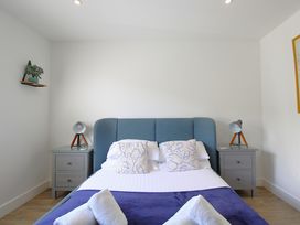 A bedroom with a double bed two bedside tables and lamps at 65 Channel View in Ilfracombe