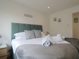 A bedroom with a bed and decorative items at 65 Channel View in Ilfracombe