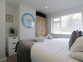 A bedroom with a bed and wardrobe at 65 Channel View Ilfracombe