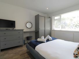 A bedroom with a bed and television at 65 Channel View Ilfracombe