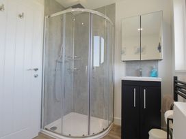 A bathroom with a shower and sink at 65 Channel View Ilfracombe