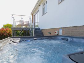 A hot tub with deck and steps at 65 Channel View Ilfracombe