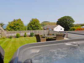 A garden with a hot tub and outdoor seating at 65 Channel View Ilfracombe