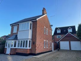 A house with a garage and pathway at The Chocolate Box in Weymouth