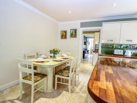A dining area with a table and chairs at Birch Cottage in Brundall