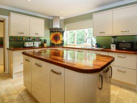 A kitchen with cabinets and appliances at Birch Cottage in Brundall