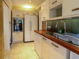A kitchen with appliances including a fridge and oven at Birch Cottage in Brundall