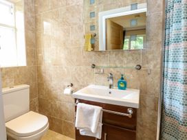 A bathroom with a sink and toilet at Birch Cottage in Brundall