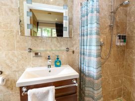 A bathroom with a sink and shower at Birch Cottage in Brundall