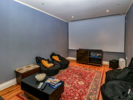 A home theater with bean bags and a coffee table at Birch Cottage in Brundall