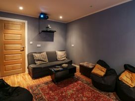 A snug with a sofa and bean bags at Birch Cottage in Brundall